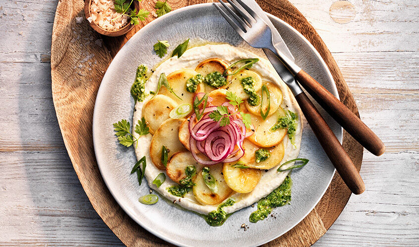 Patates sobre hummus i pesto de bròcoli